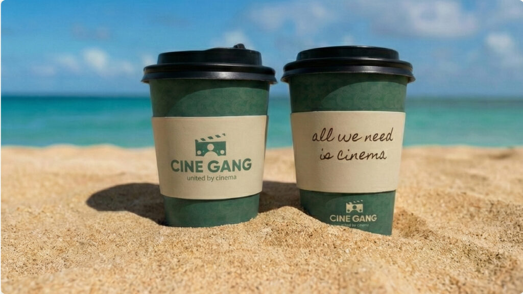 Cine Gang branded coffee cups mockup displayed on beach setting